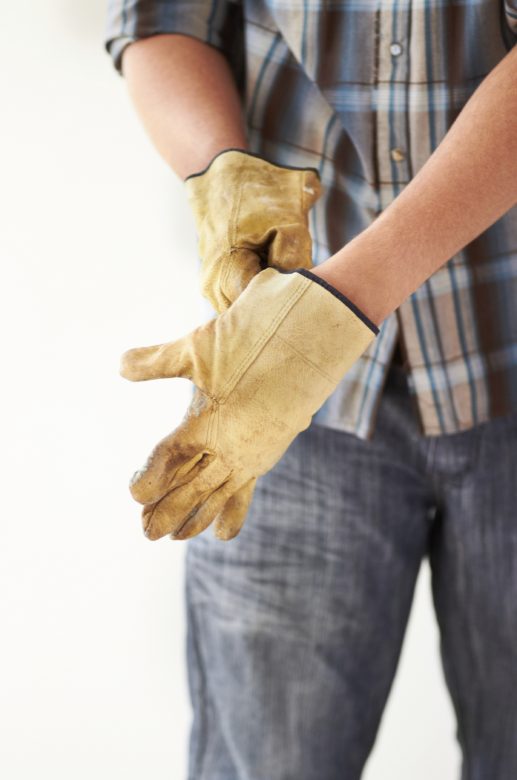 A worker puts on safety gloves