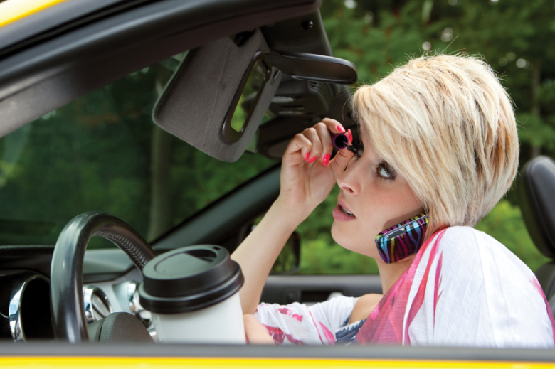 Woman distracted by multiple things while driving