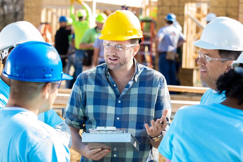 Supervisor delivering toolbox talk on construction site