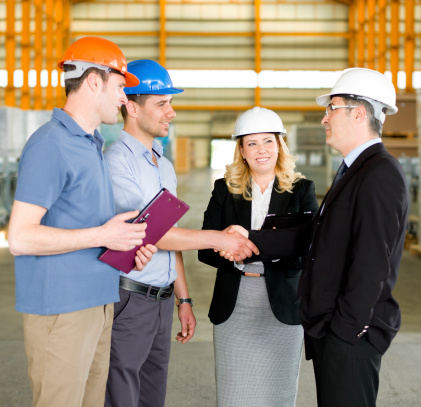 Business leaders shake hands with a safety manager