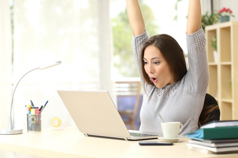 Young woman excited about winning online