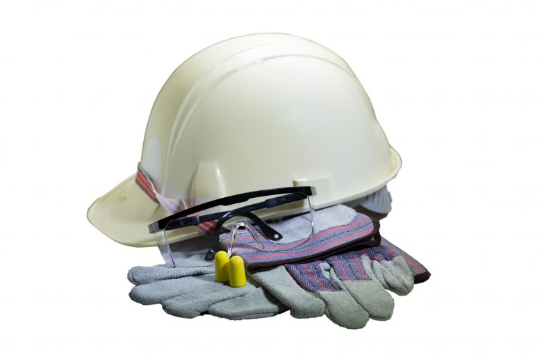 Assorted collection of PPE including hardhat, gloves, safety glasses and ear protection.