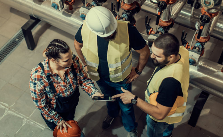 Workers engaged in plan on factory floor