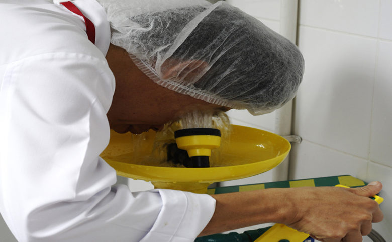 worker is using eyewash station