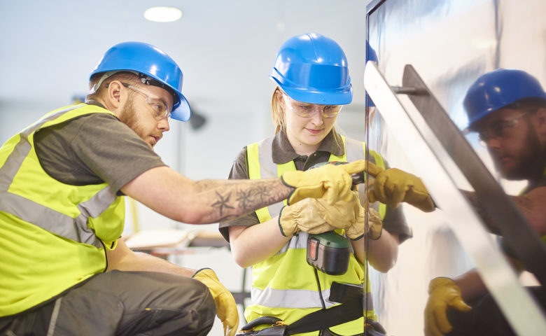 Young worker learning how to perform job safely