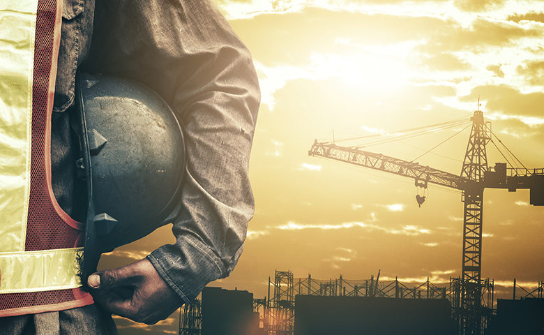 Construction worker working near a crane on a construction site