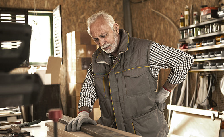 Senior carpenter having back pain