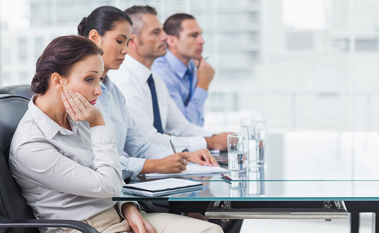 Businesswoman getting bored while attending presentation