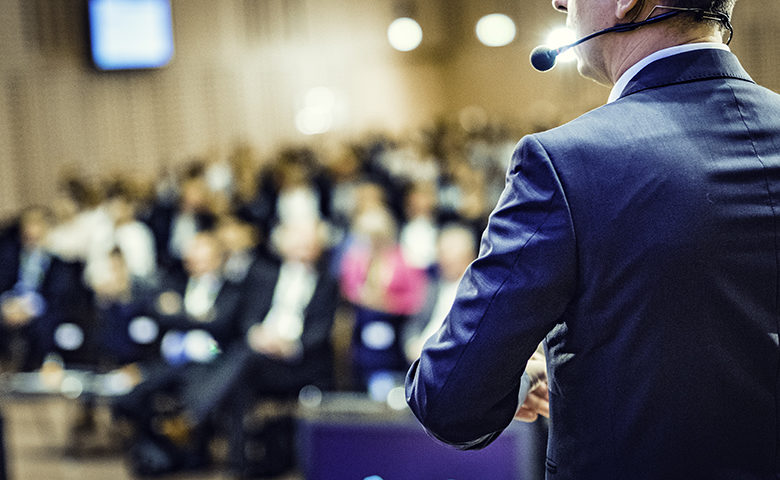 Rear view of a speaker at a conference