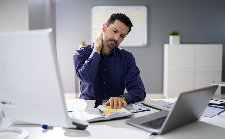 Businessman Suffering From Neck Pain