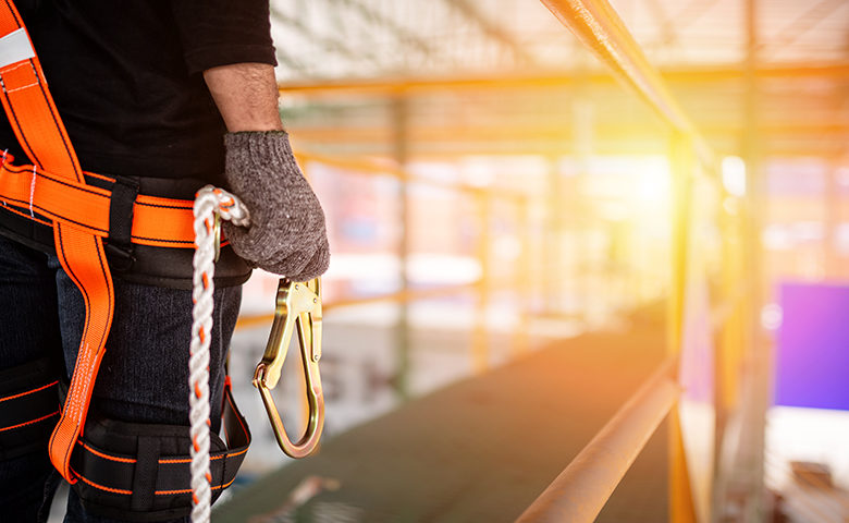 Construction worker wearing safety harness and safety line