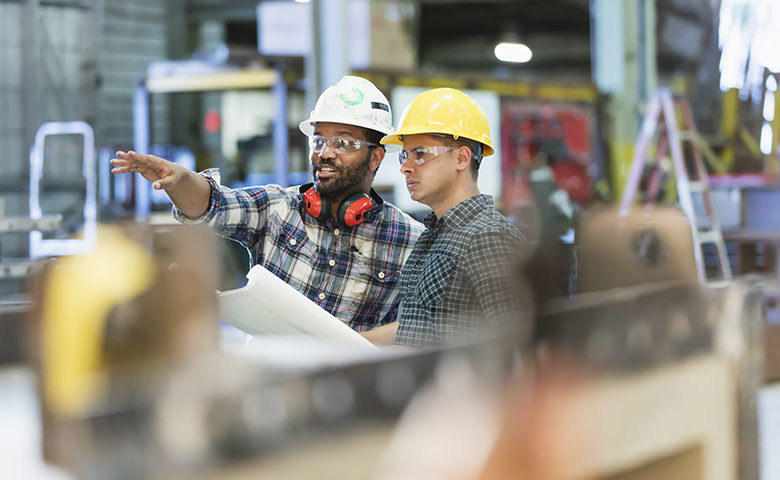 Supervisor and worker talking on shop floor