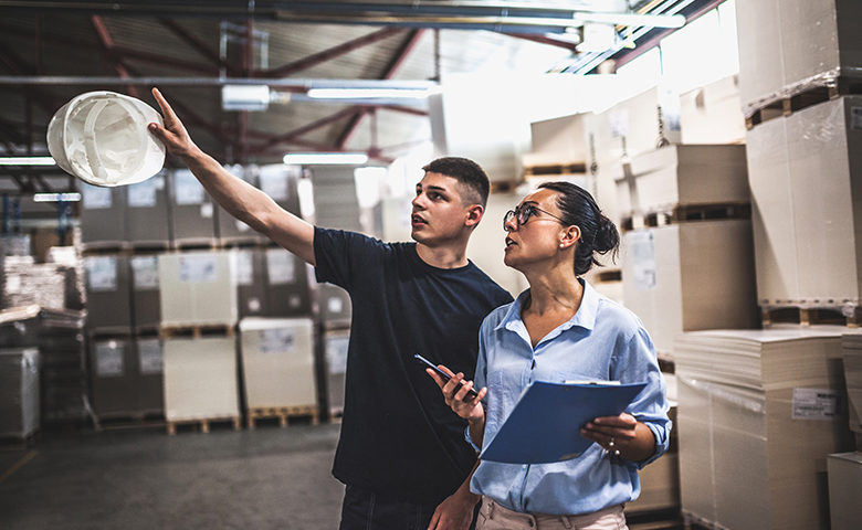 Warehouse worker and manager looking at safety concern