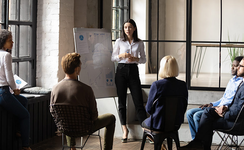 Confident lady business trainer coach give flip chart toolbox presentation