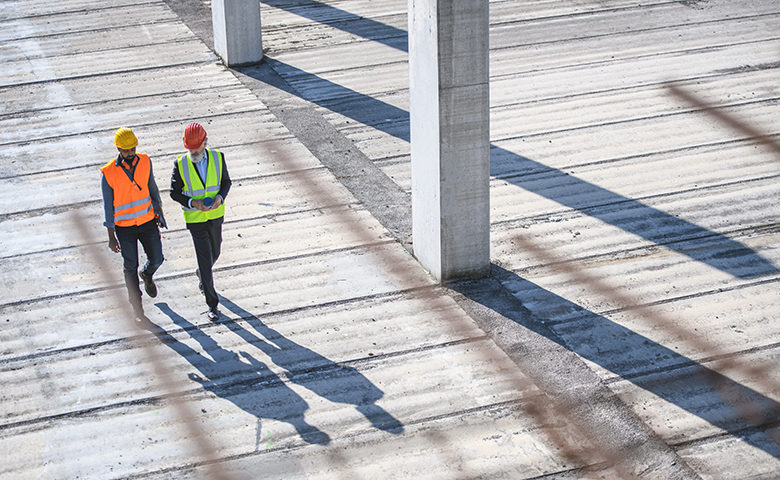 Supervisor and safety manager walking on worksite