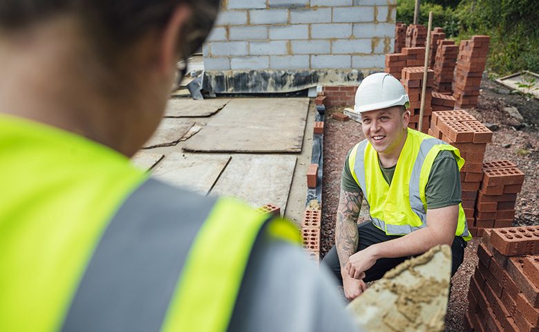 Construction workers talking on the job site