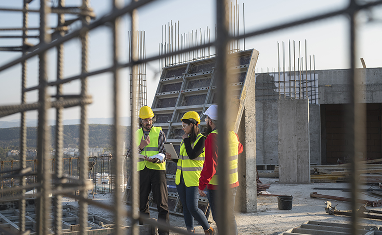 Construction workers discuss the job.