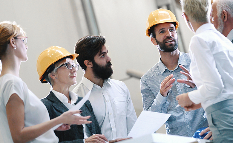 Team engaged in conversation on construction site