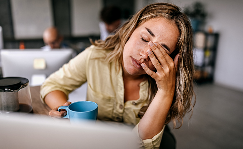 Tired business woman rubbing eyes