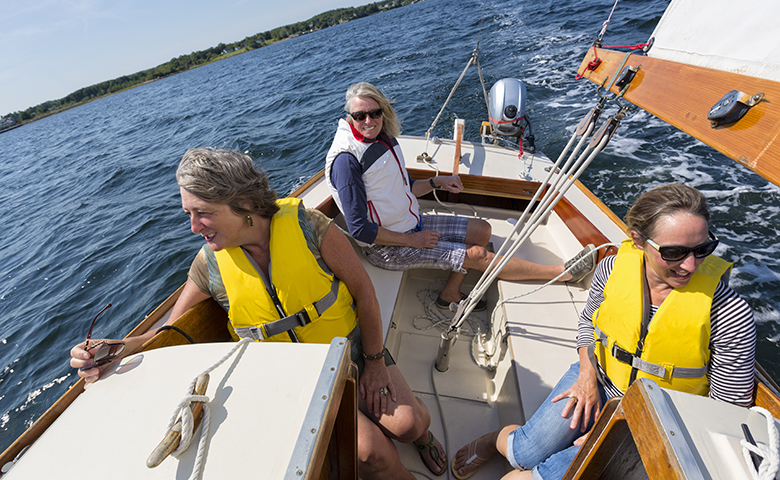 Friends sailing on a boat safely