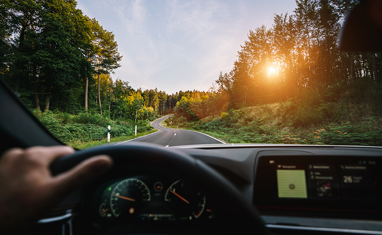 hands of car driver on steering wheel, road trip, driving on highway road