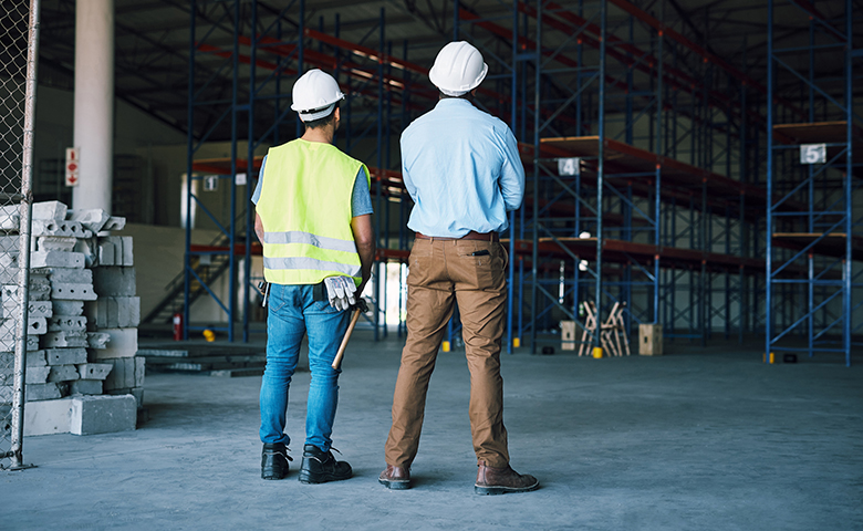 Shot of two builders inspecting a construction site