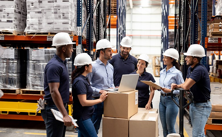 Business manager talking to a group of employees at a distribution warehouse